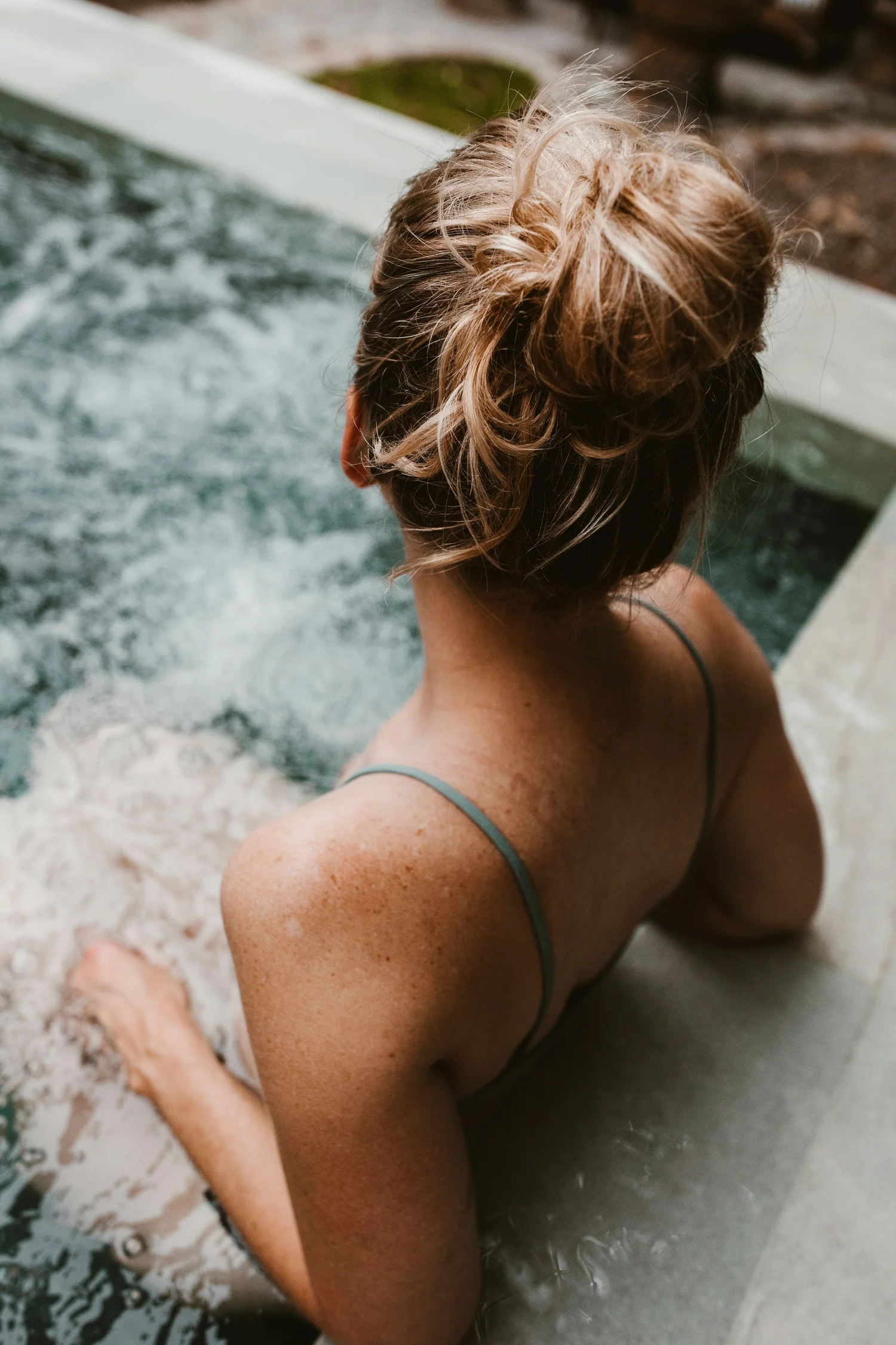 A spa guest relaxing by a pool